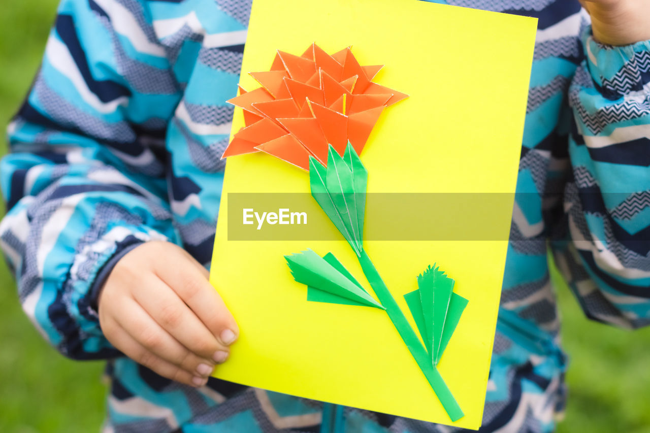 Greating card for the may 9 victory day . children's creativity. boy demonstrates handmade card