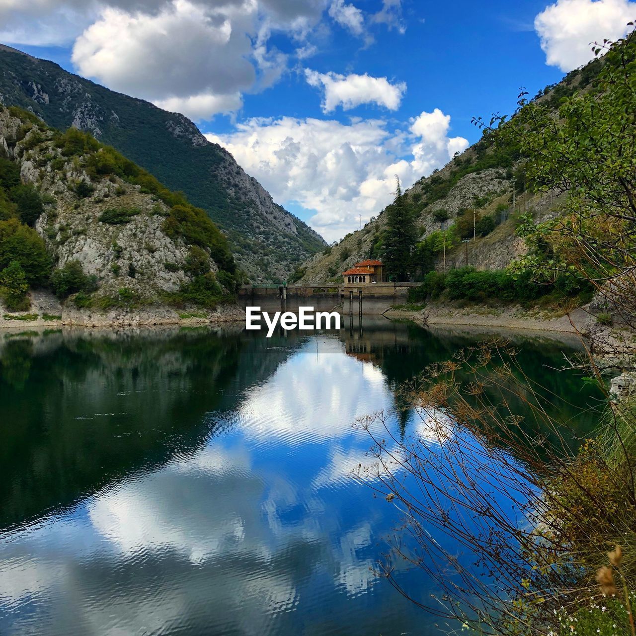 Scenic view of lake and mountains against sky