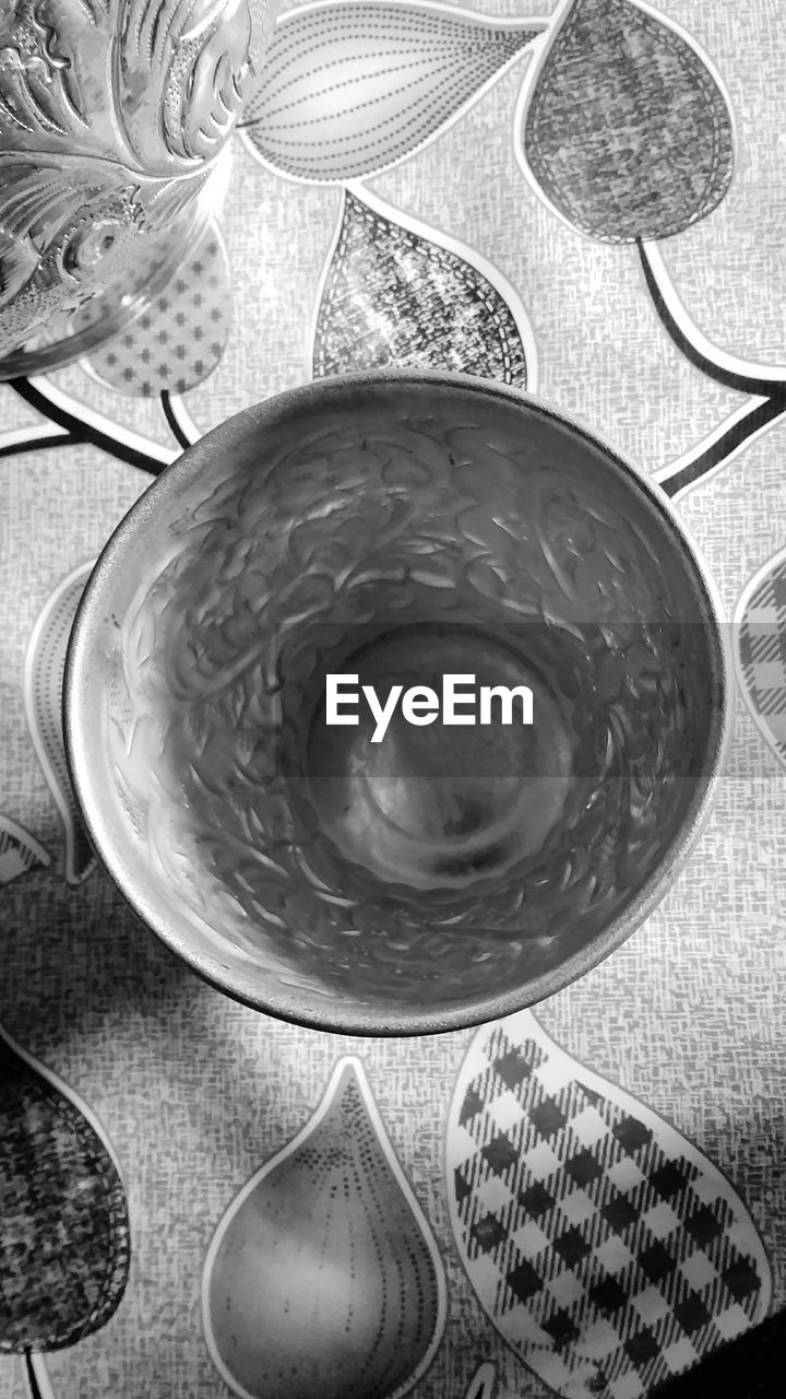 DIRECTLY ABOVE SHOT OF BEER ON GLASS TABLE