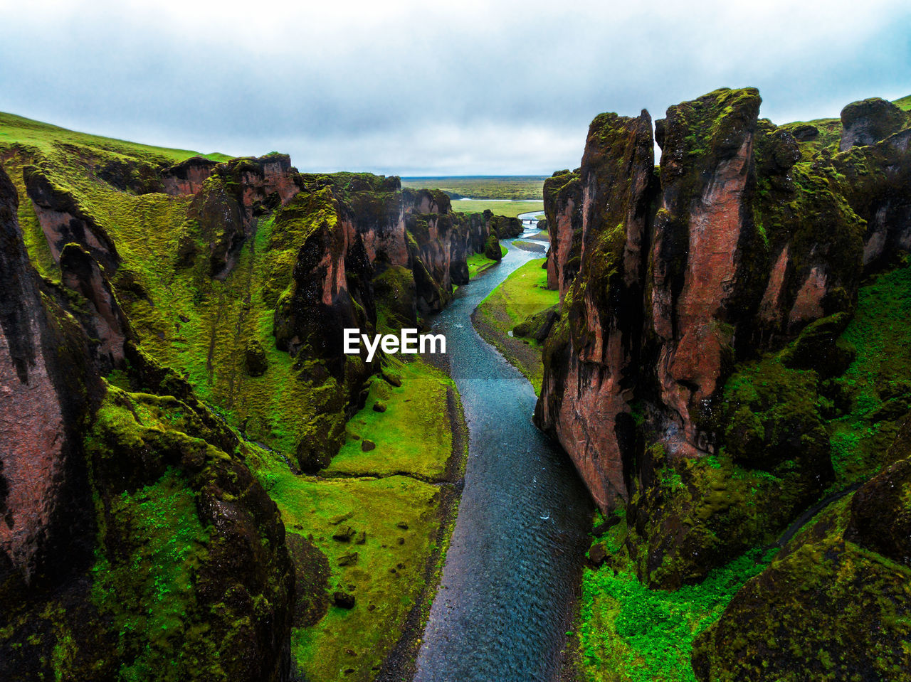 River amidst mountains against sky