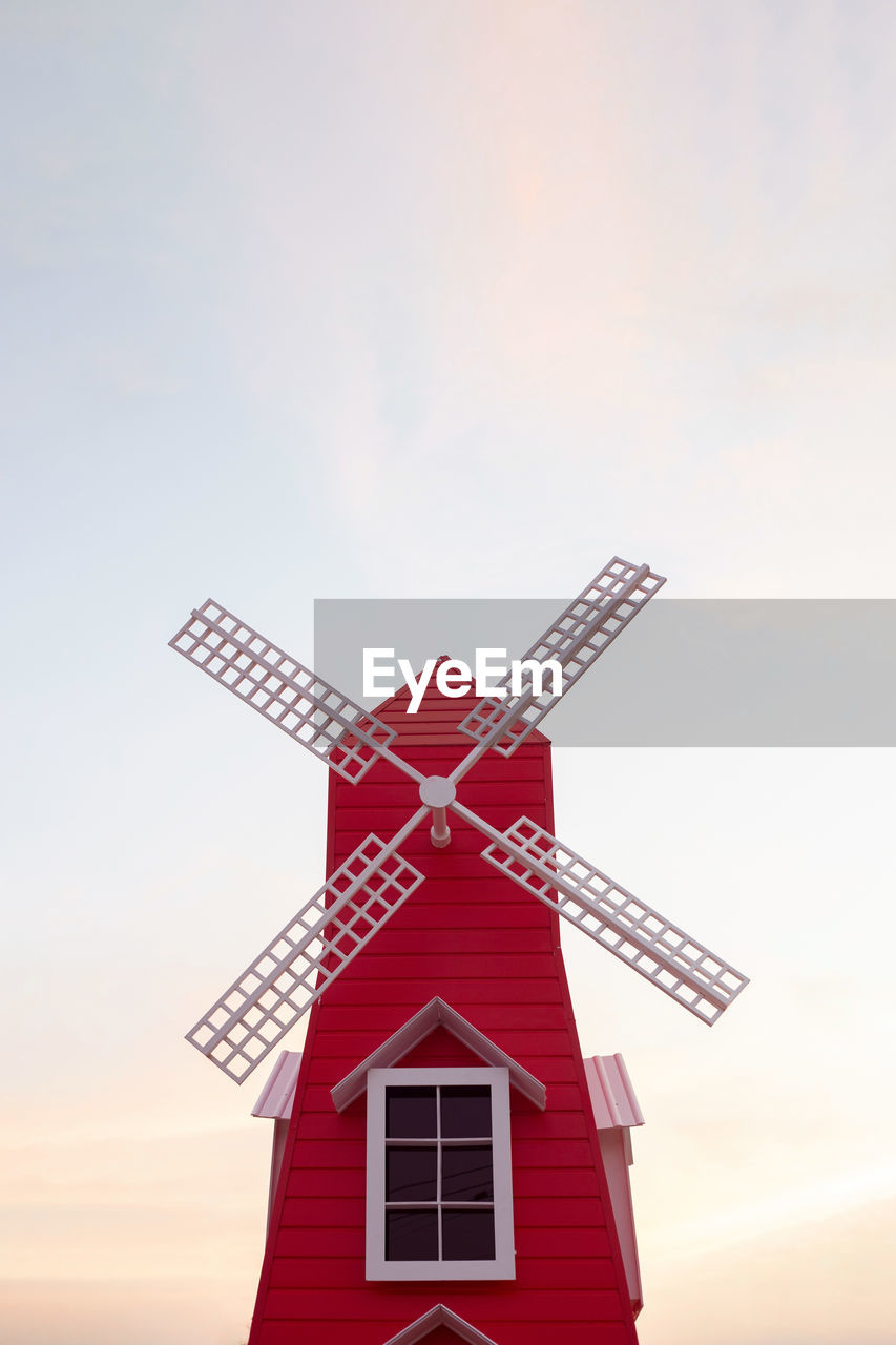 Low angle view of traditional windmill against sky