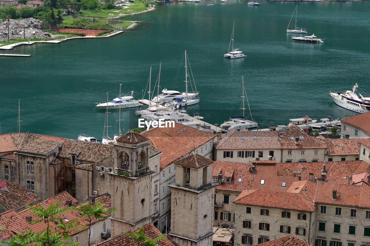 High angle view of sea by buildings in city