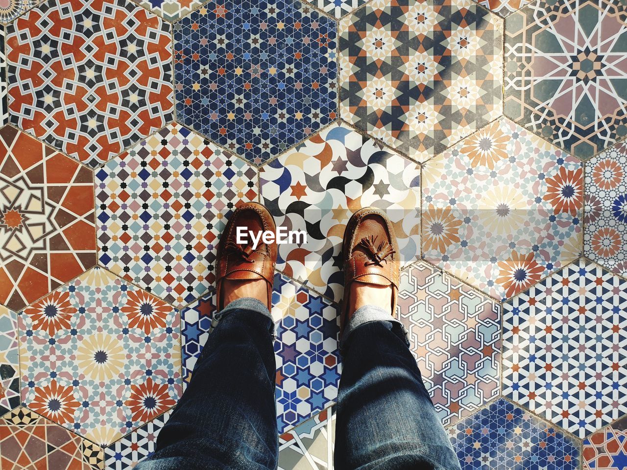 Low section of woman standing on tiled floor