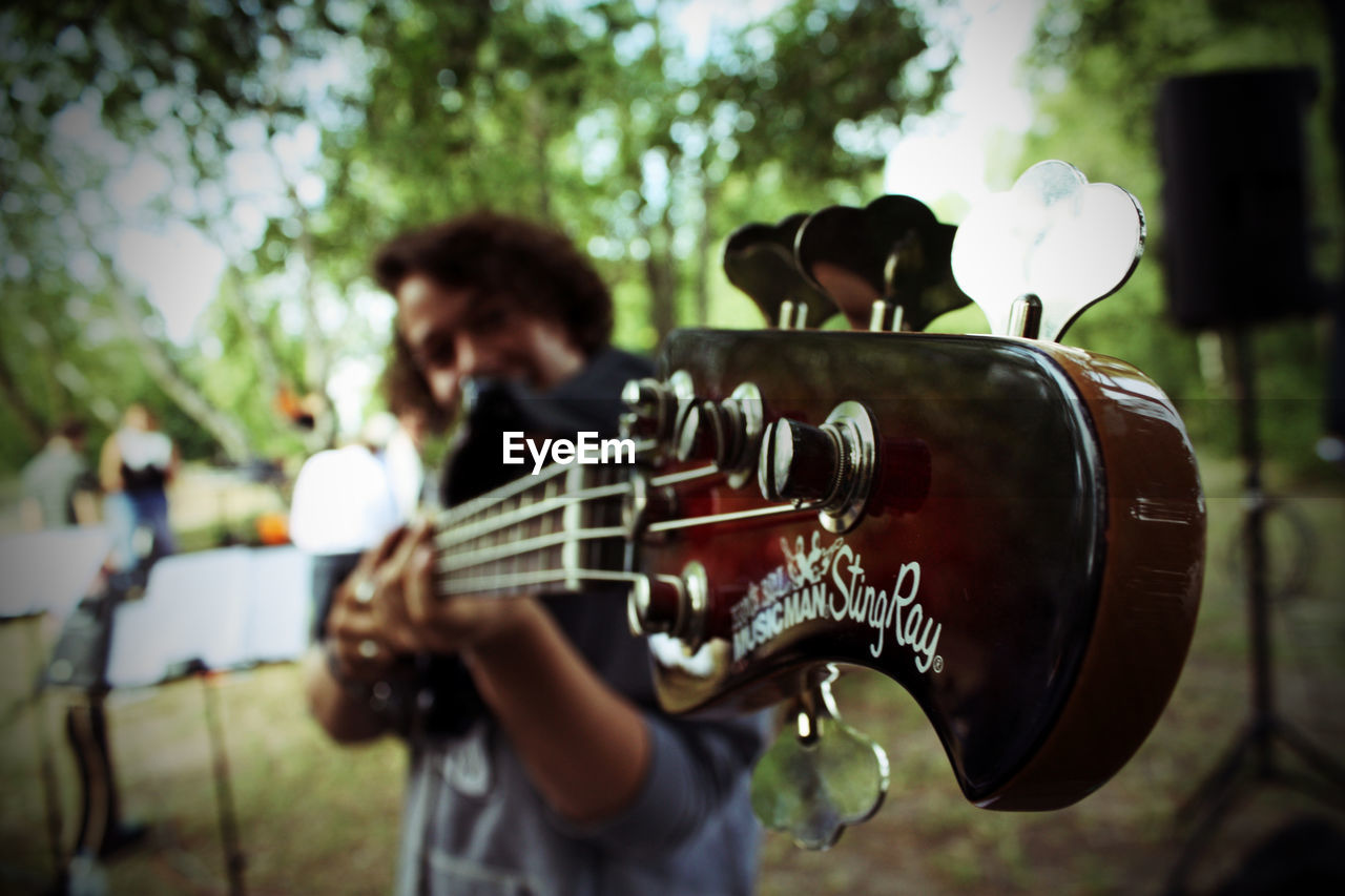 PERSON PLAYING GUITAR