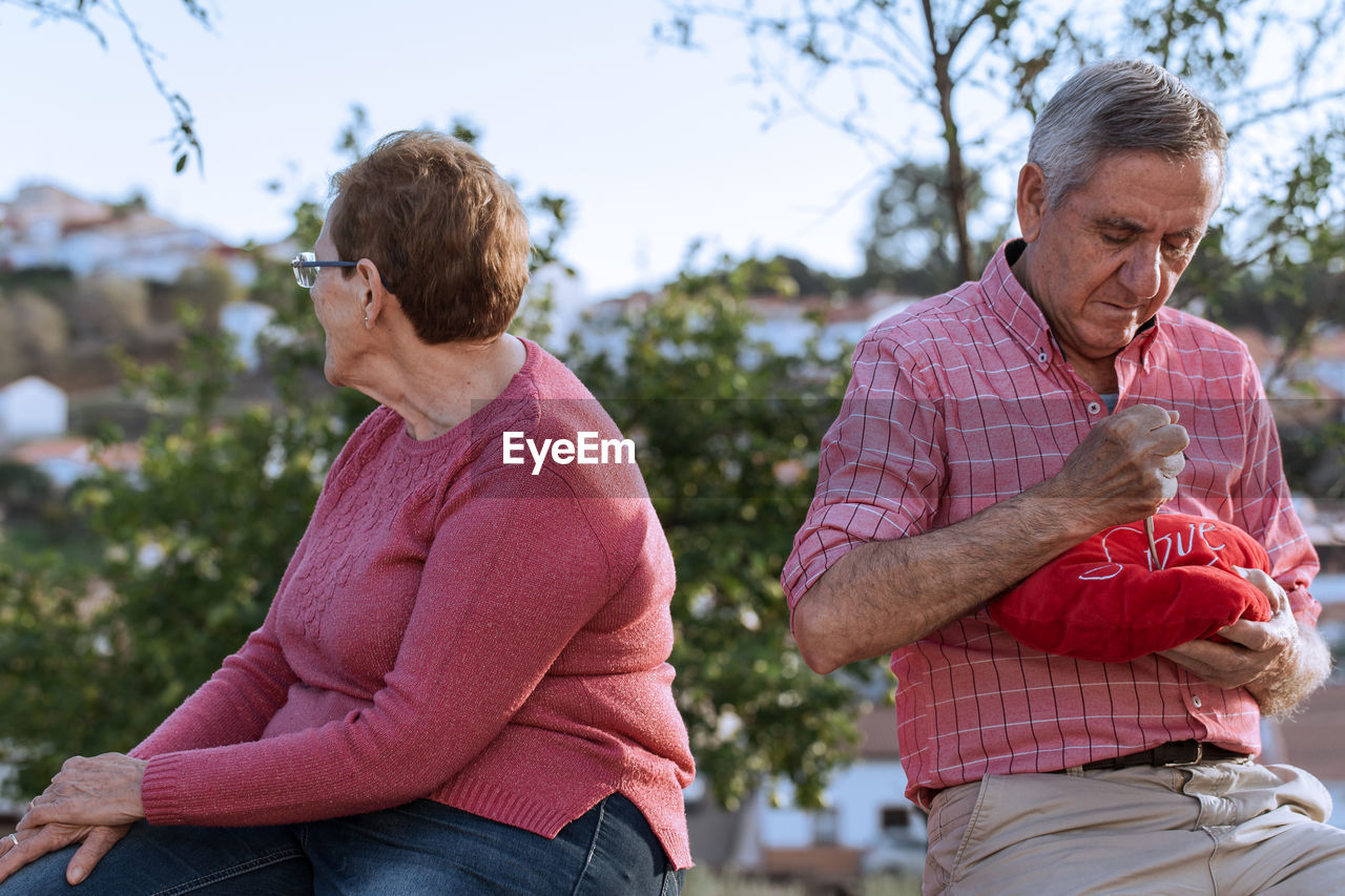 Angry couple sitting outdoors