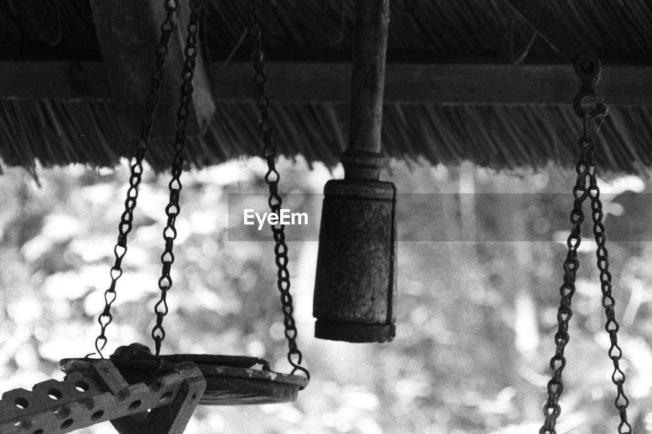 LOW ANGLE VIEW OF SWING HANGING ON PLAYGROUND
