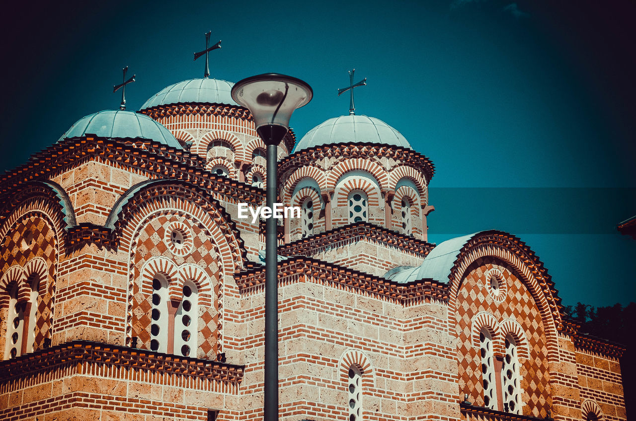 Low angle view of ornate building against blue sky