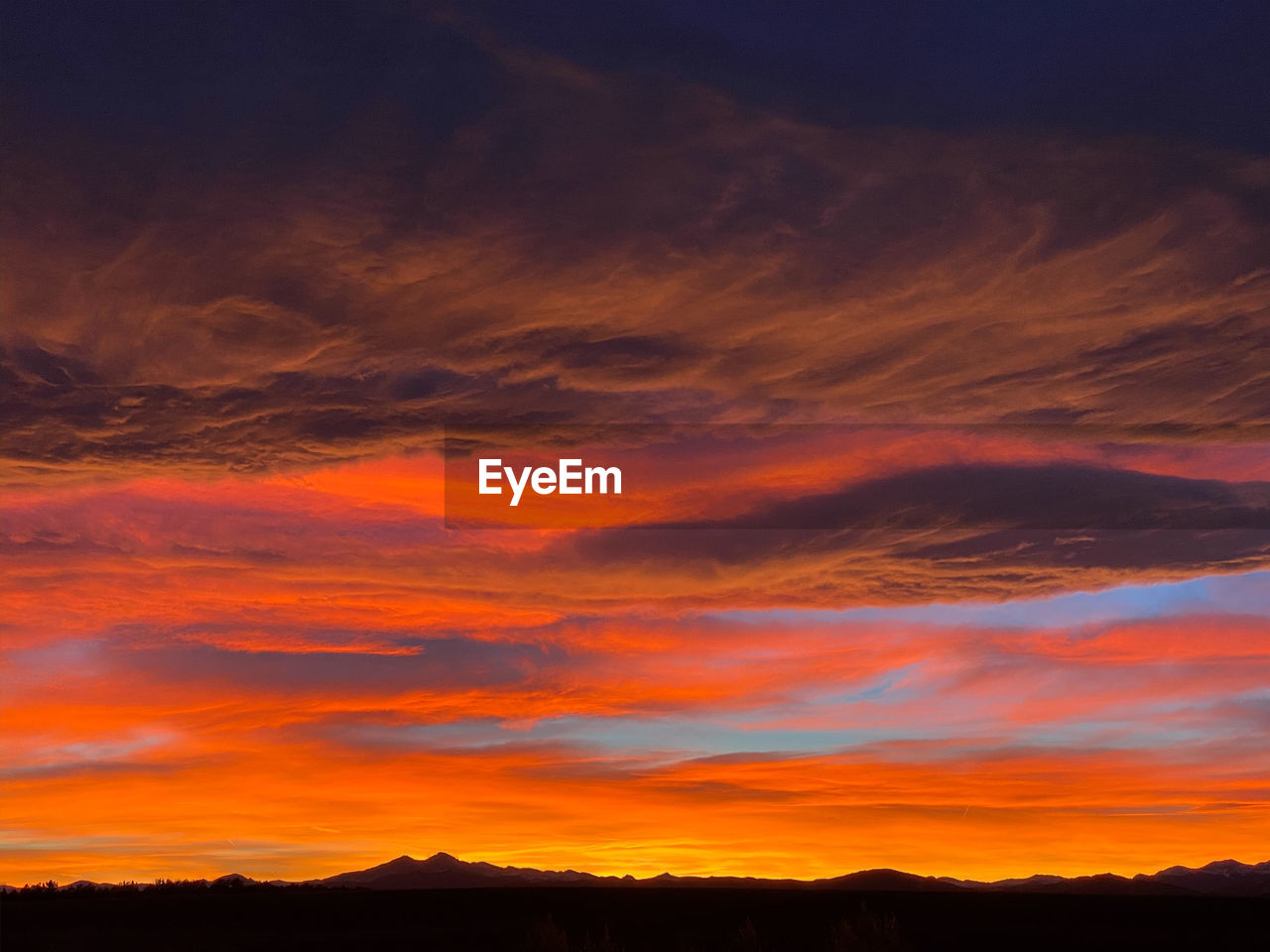 SCENIC VIEW OF DRAMATIC SKY OVER SILHOUETTE LANDSCAPE