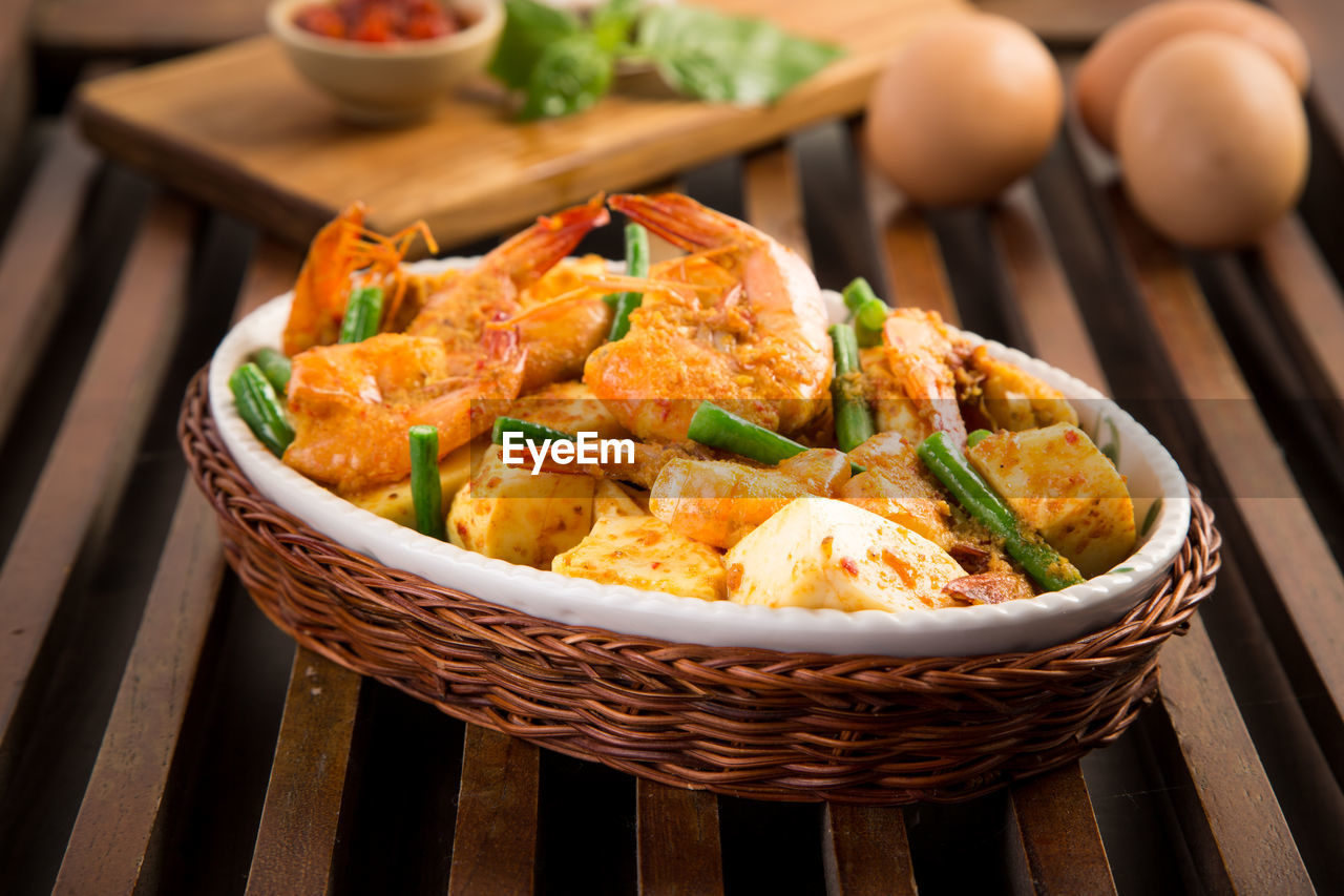 Close-up of fried tofu with shrimps on wooden table