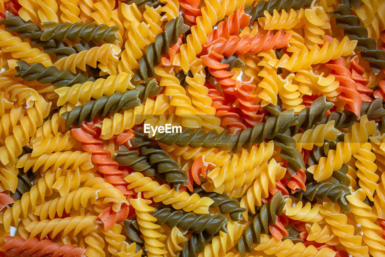 fusilli, rotini, full frame, food, food and drink, freshness, backgrounds, abundance, dish, yellow, large group of objects, no people, pasta, cuisine, retail, still life, market, for sale, vegetable, high angle view, close-up, produce, healthy eating, variation, multi colored, italian food, wellbeing, corn, flower, indoors, raw food