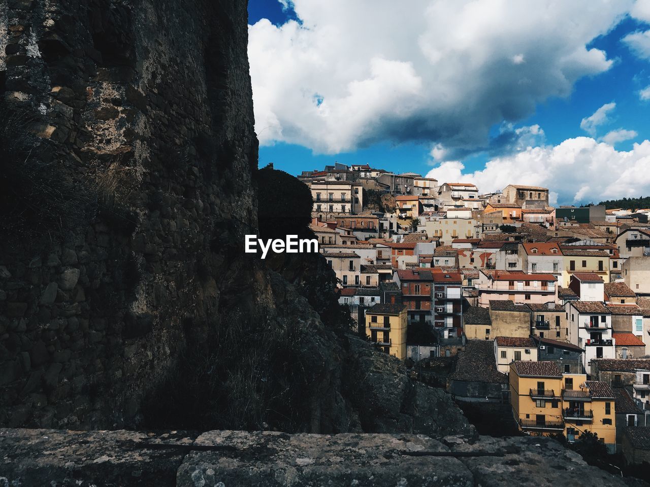 Buildings against cloudy sky