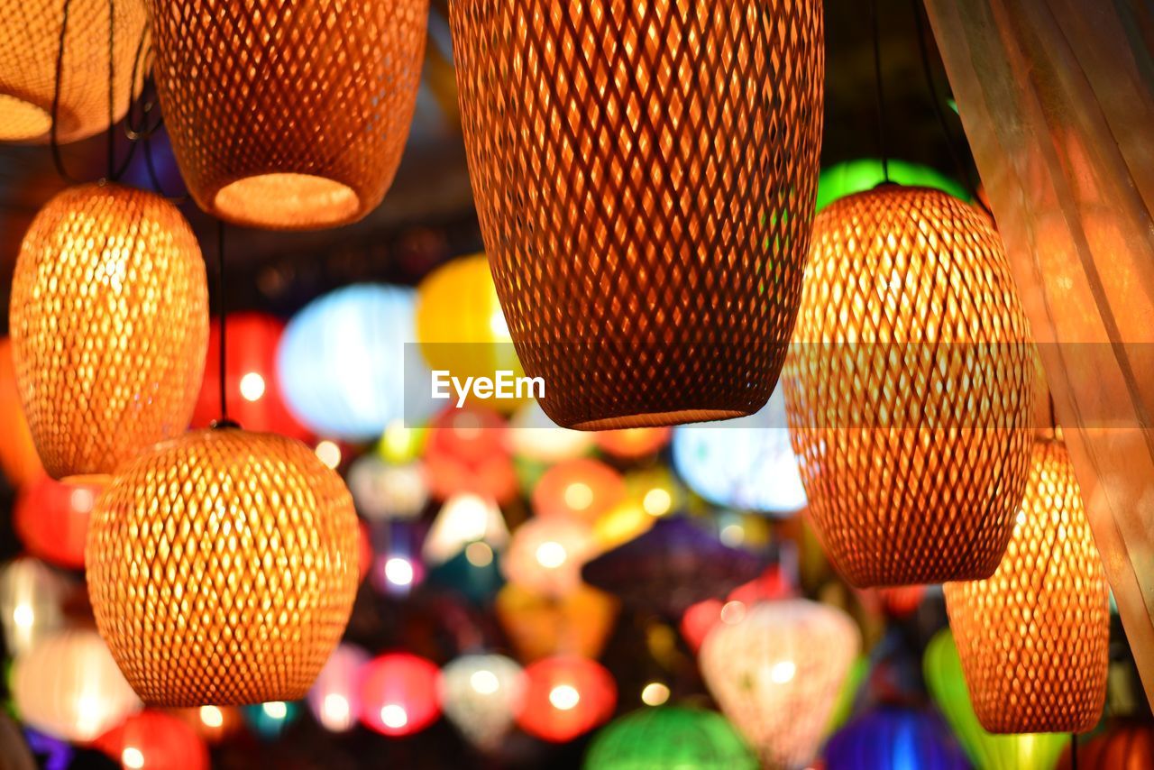 Low angle view of illuminated lanterns hanging at night