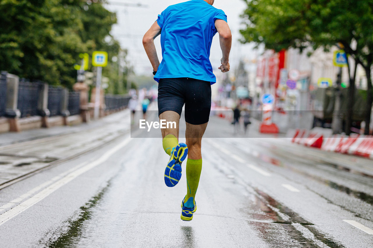 low section of man exercising on road