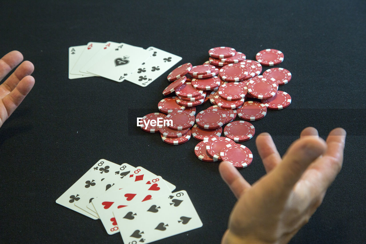 Close-up of man playing poker on table