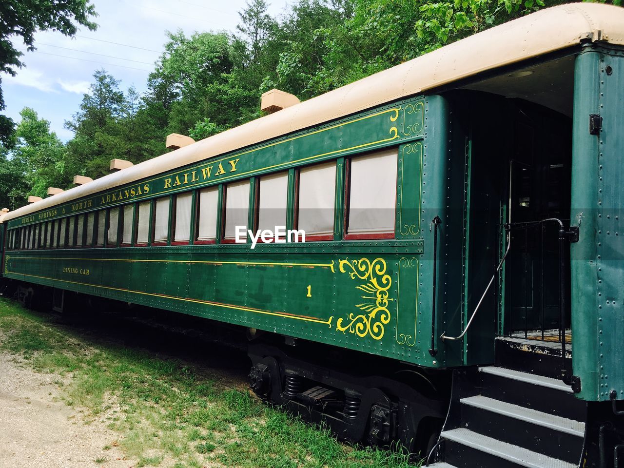 Train on field against trees