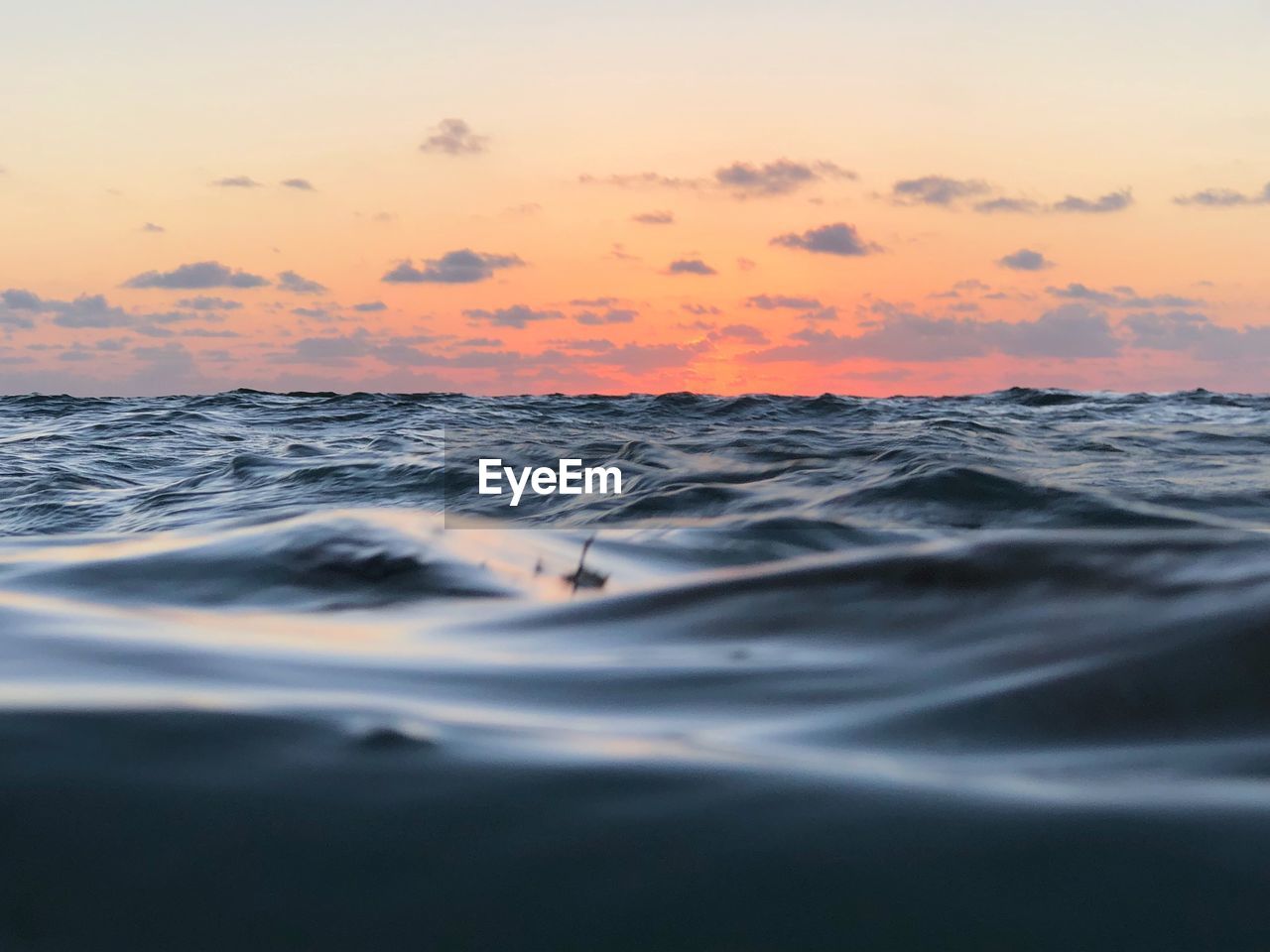 SCENIC VIEW OF SEA AGAINST ORANGE SKY