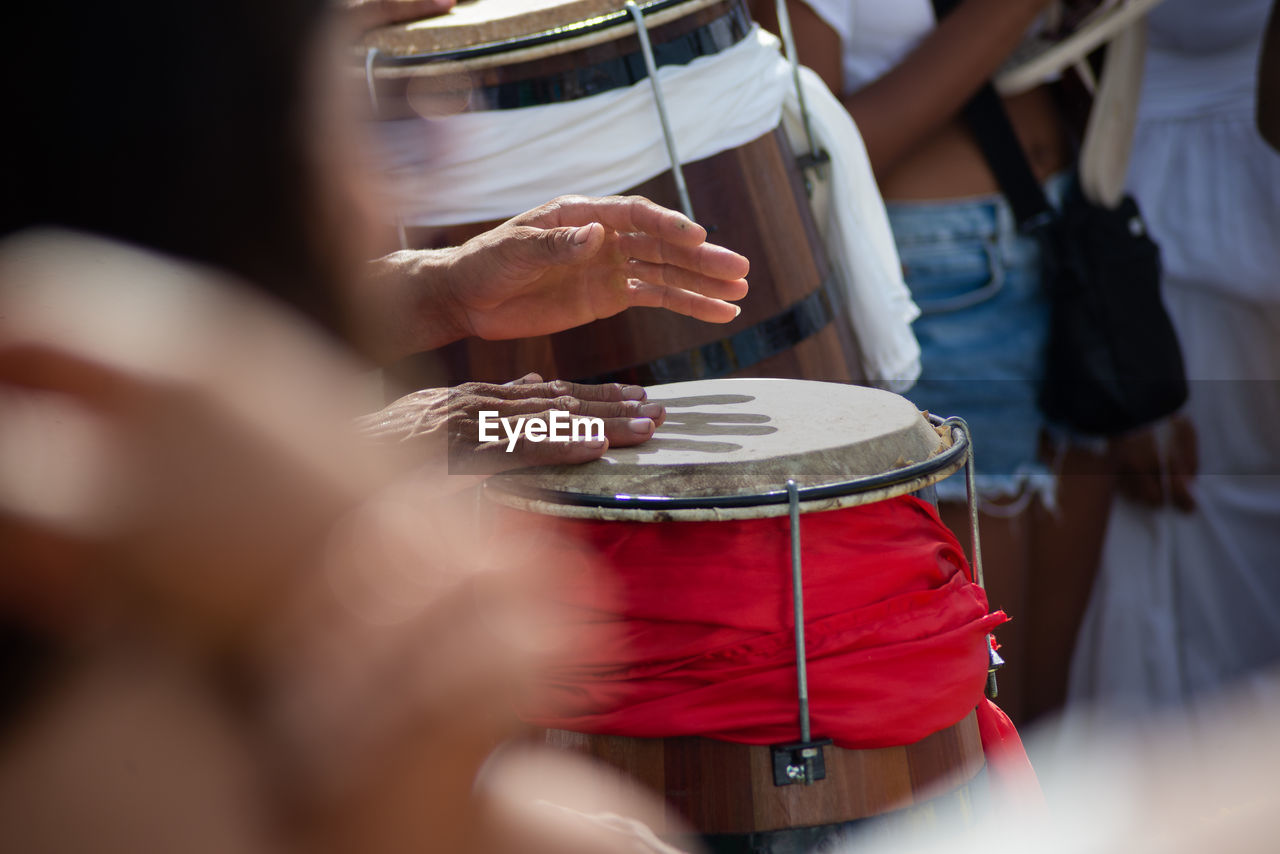 Percussionist hands playing atabaque.