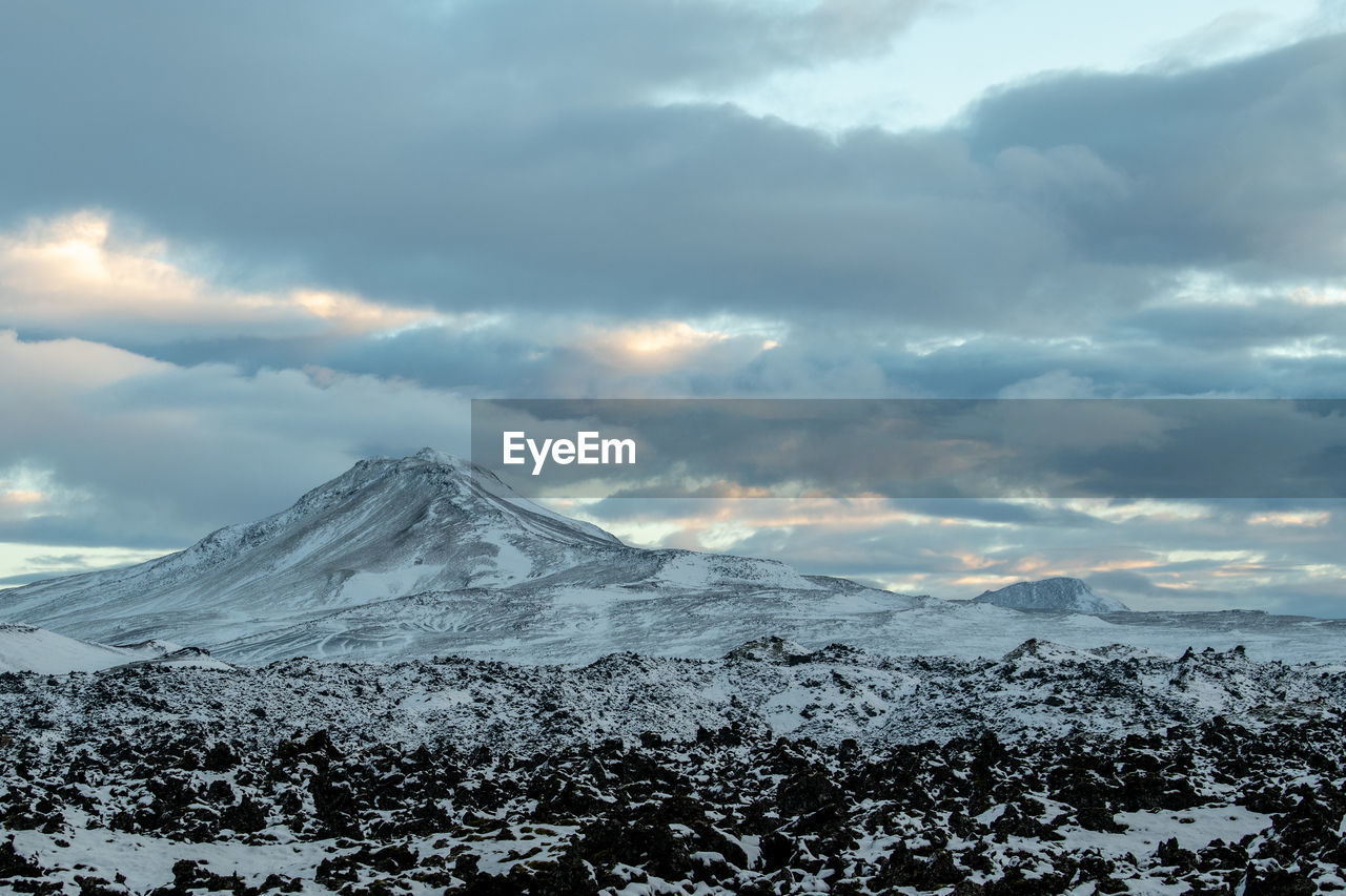 SNOW COVERED MOUNTAINS AGAINST SKY