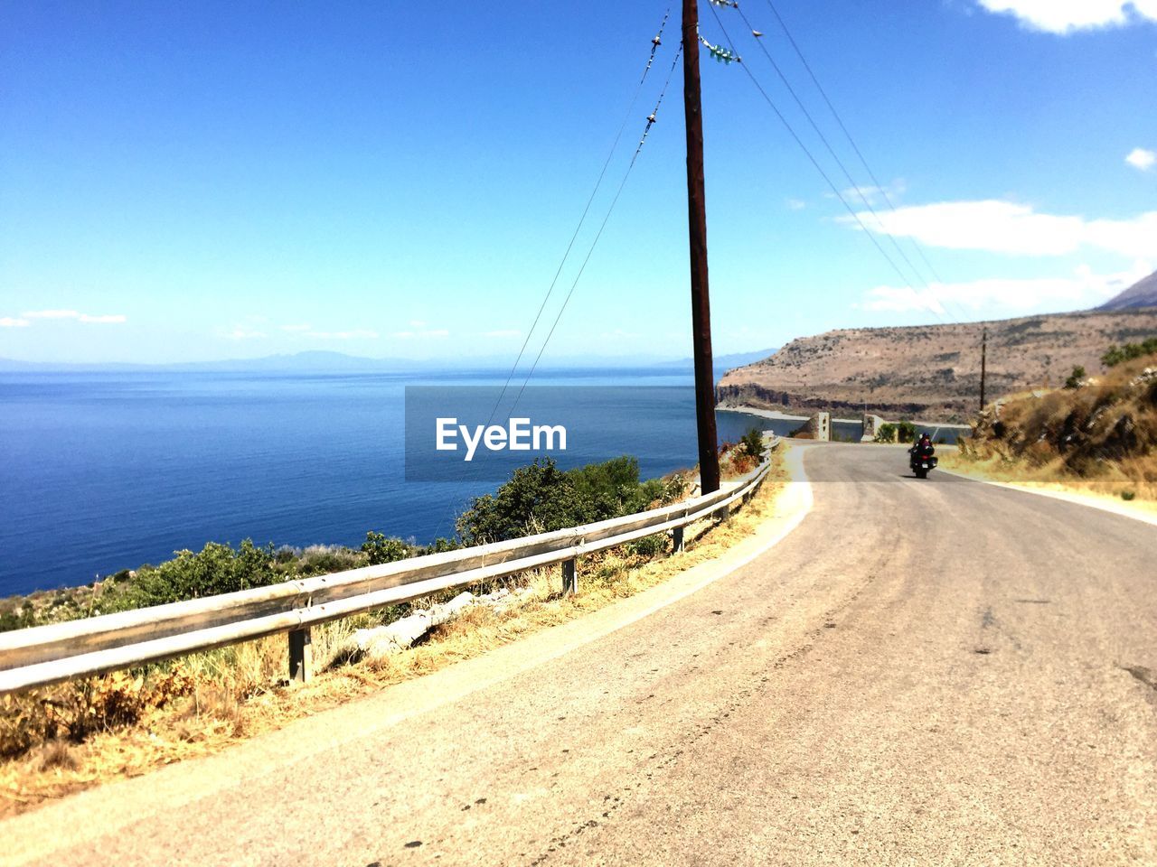 Road by sea against sky