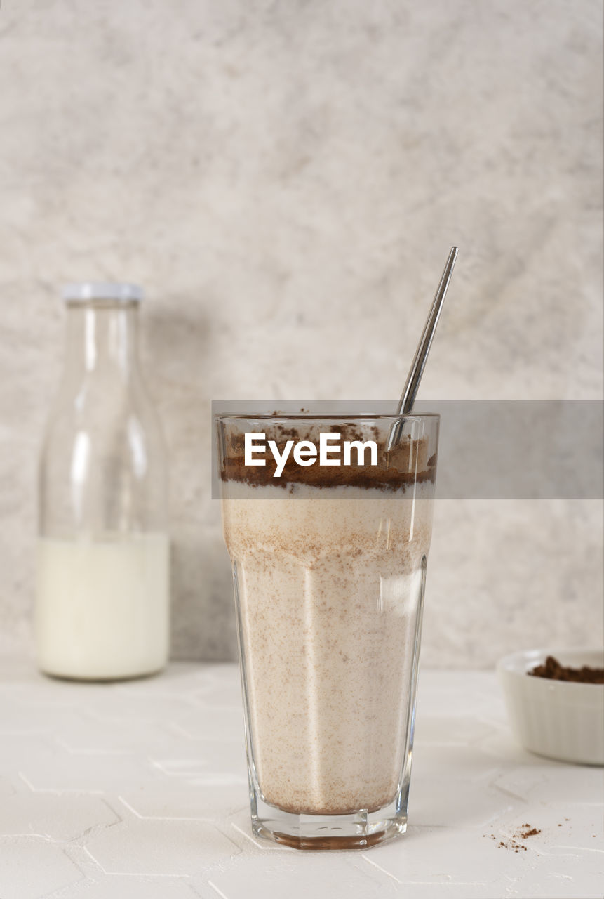 Delicious homemade cocoa drink with milk and cocoa powder. vertical orientation.