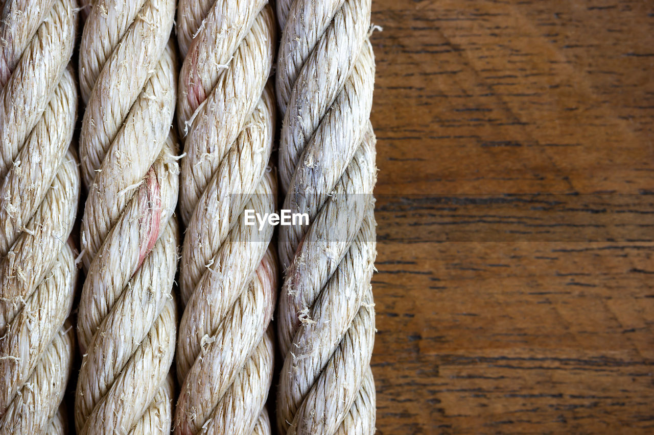 Close-up of rope against wood