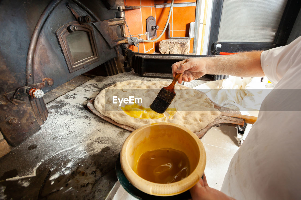 Production of baked bread with a wood oven in a bakery.