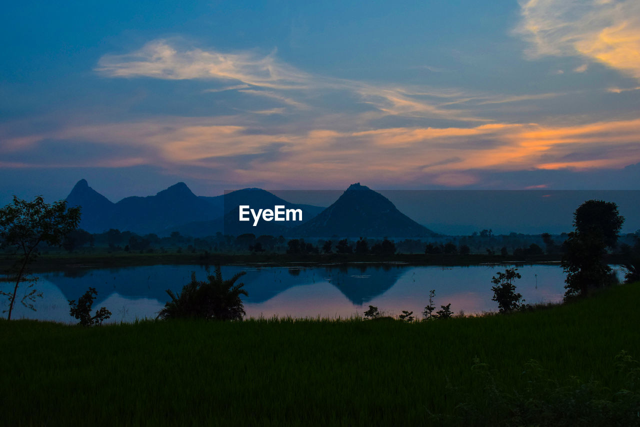 Scenic view of lake against sky during sunset