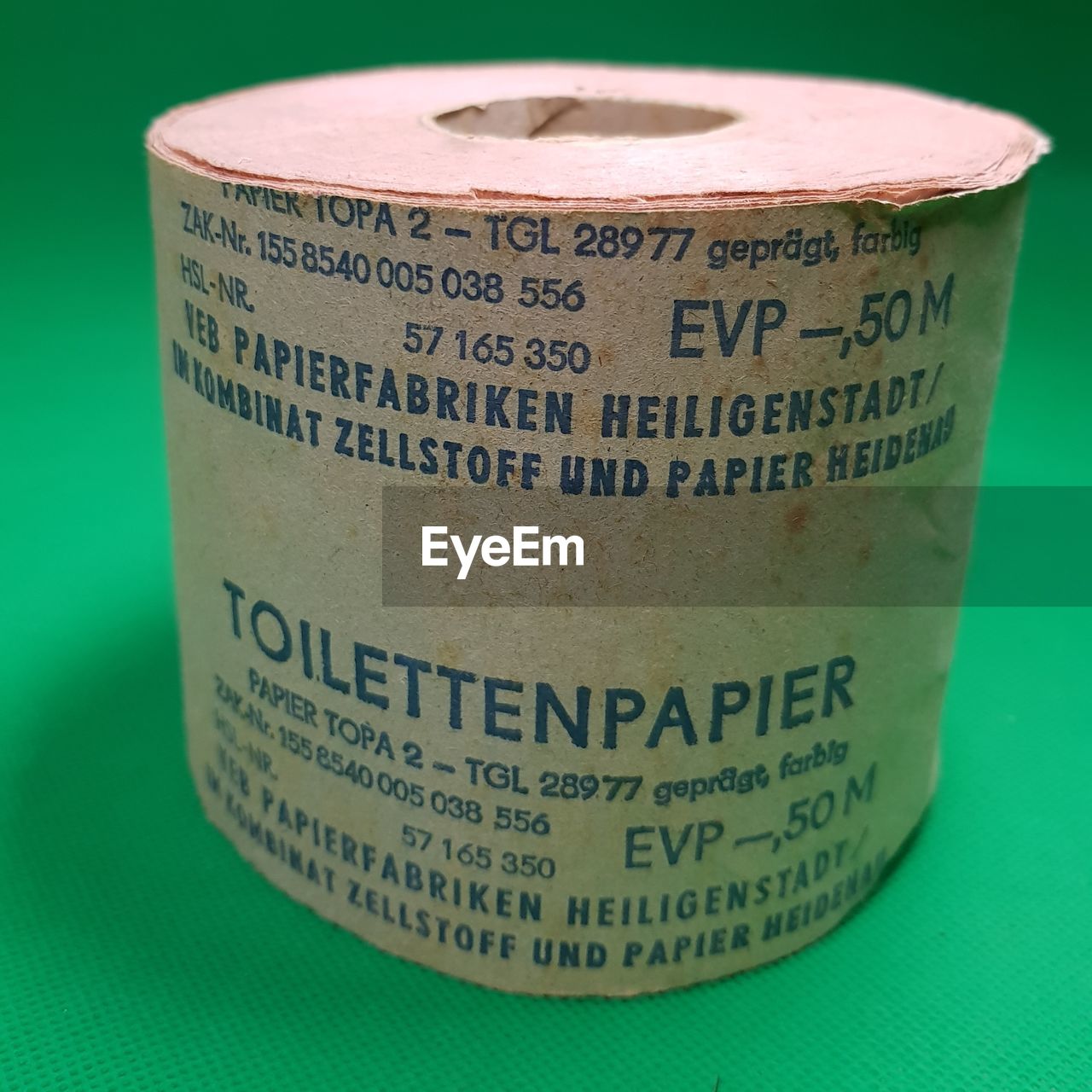 CLOSE-UP OF COFFEE CUP OVER GREEN COLORED BACKGROUND