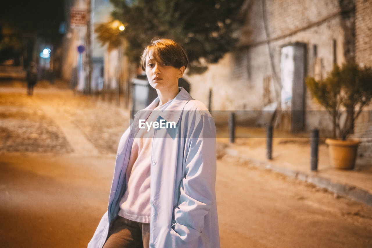 FULL LENGTH OF WOMAN STANDING ON STREET