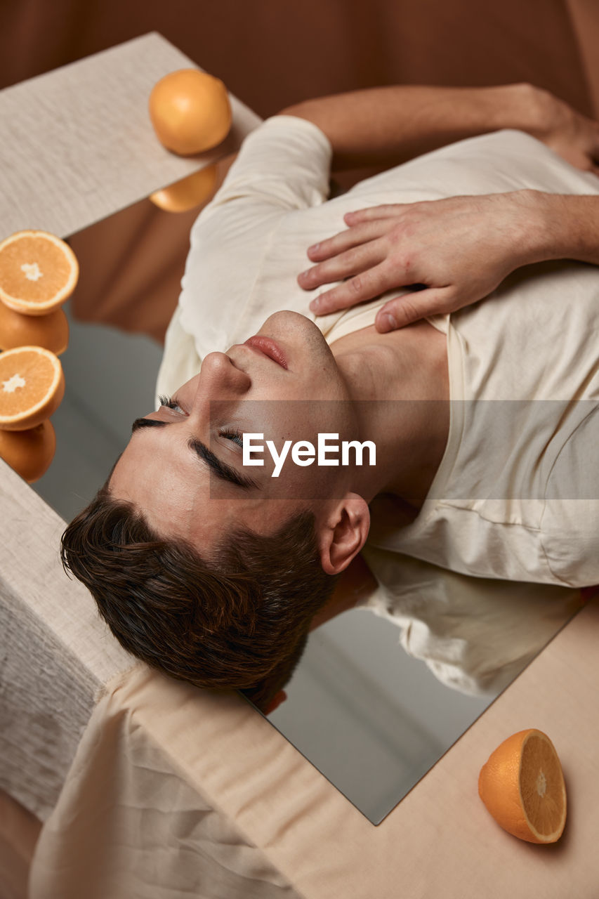 Portrait of man lying on table