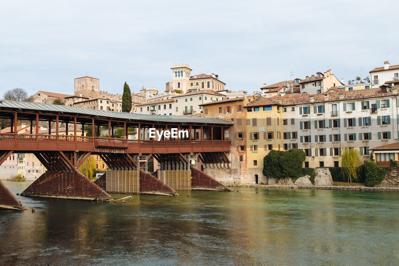 River by built structures against sky