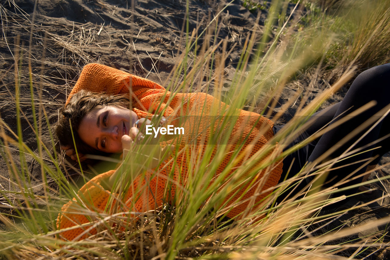 Smiling woman plays in the sand dunes