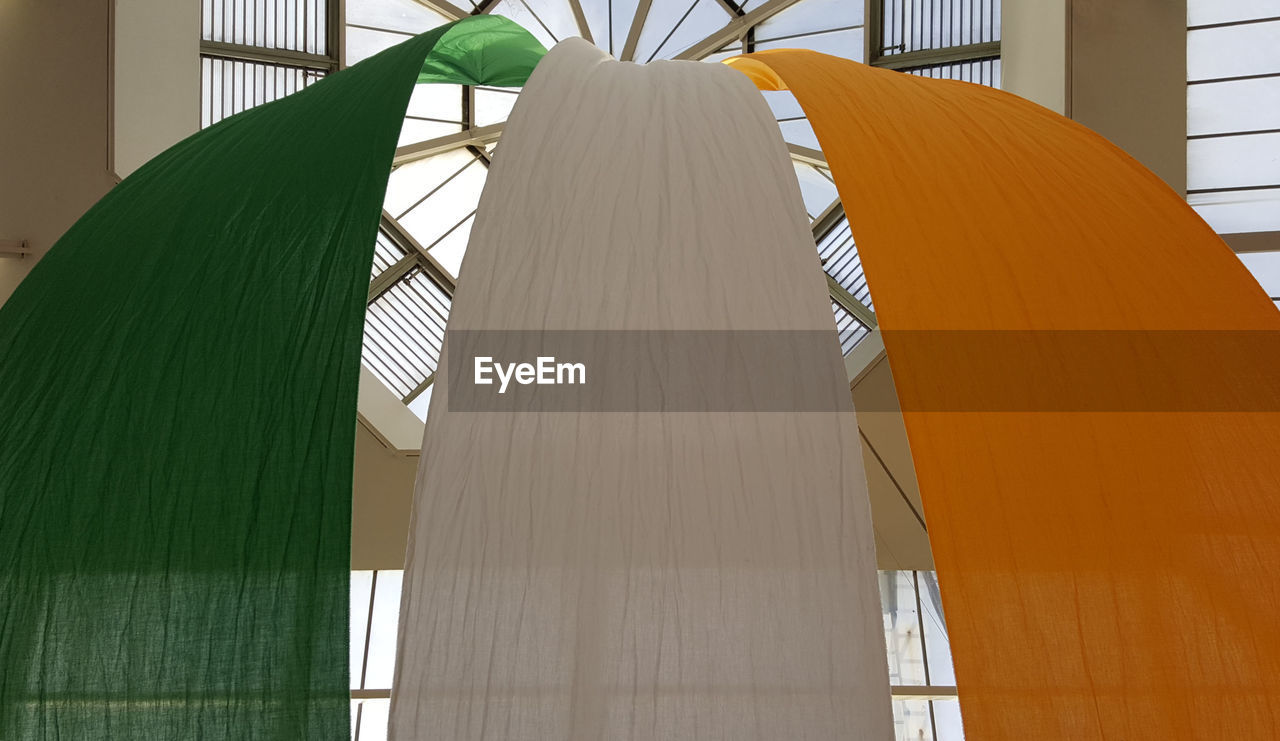 Low angle view of irish flag hanging on skylight