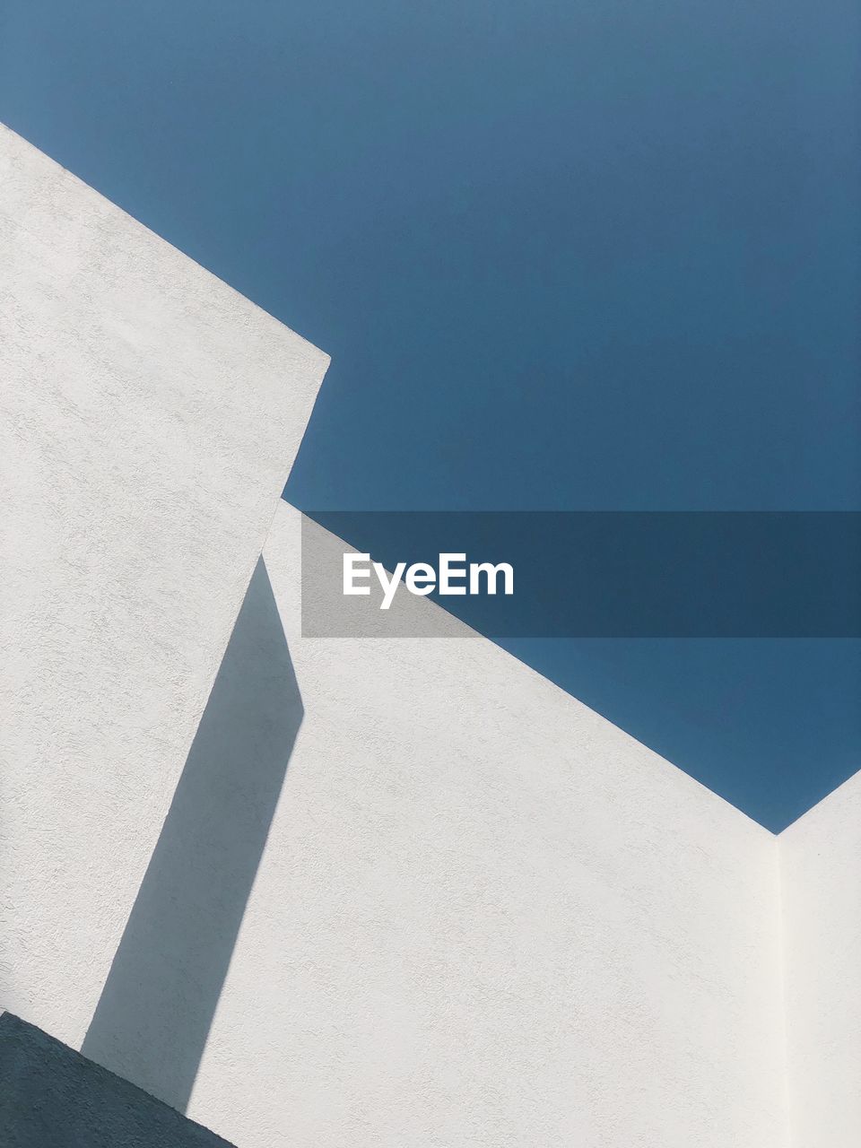 Low angle view of white building against blue sky