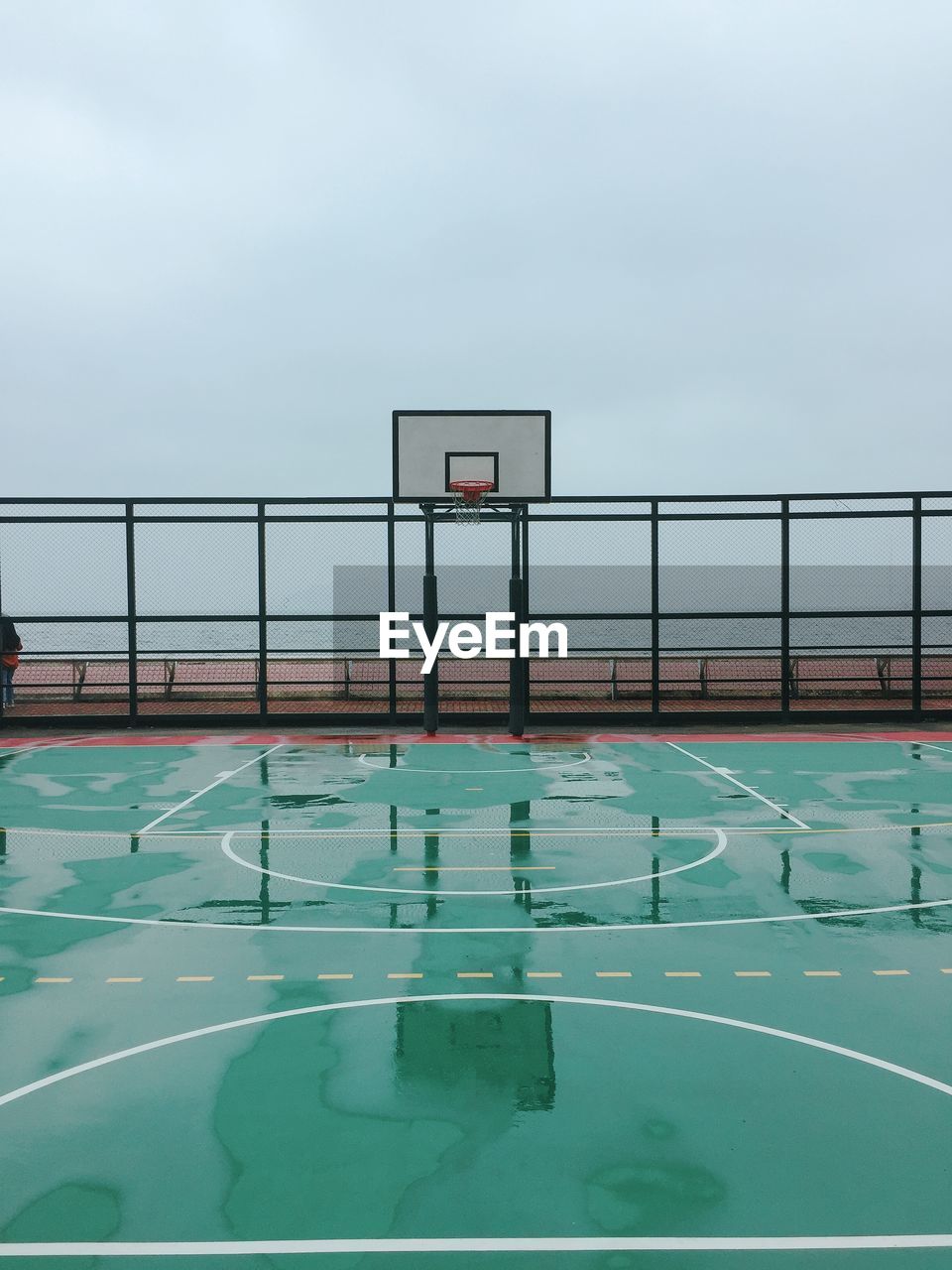 REFLECTION OF BASKETBALL HOOP ON WATER