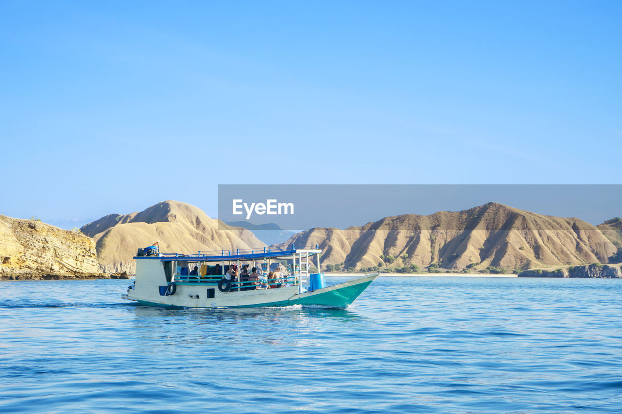 BOAT IN SEA AGAINST CLEAR SKY