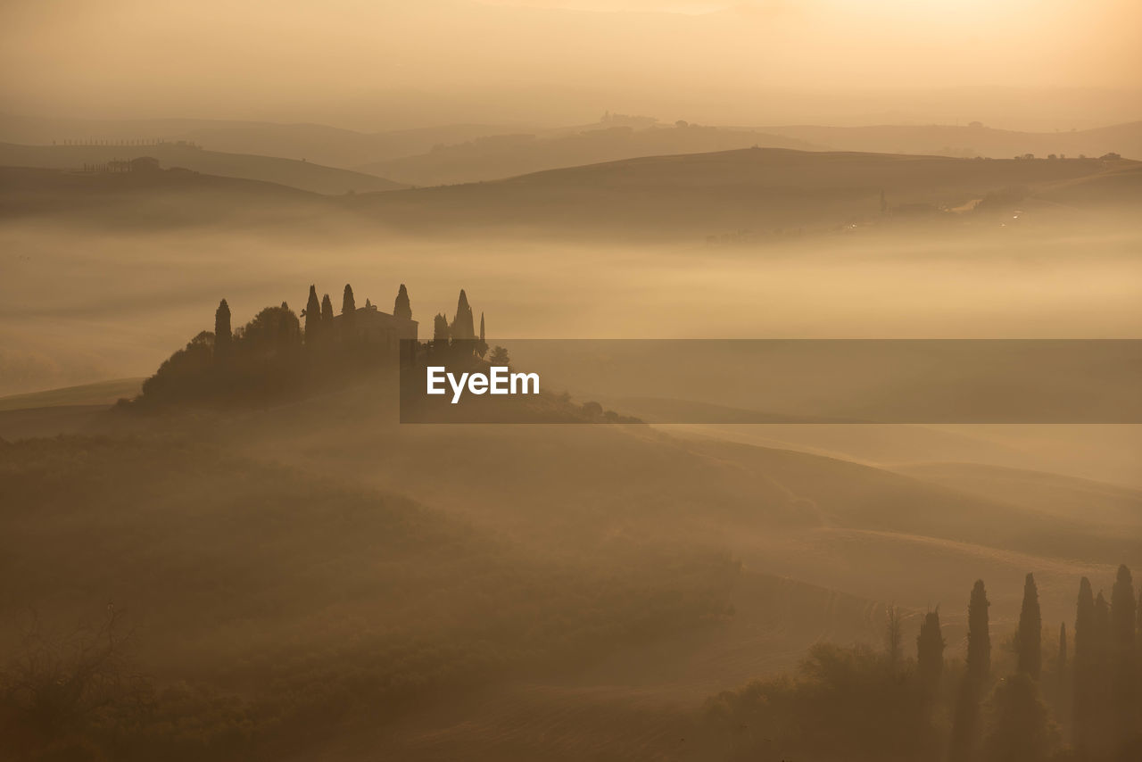 SCENIC VIEW OF MOUNTAINS AT SUNSET