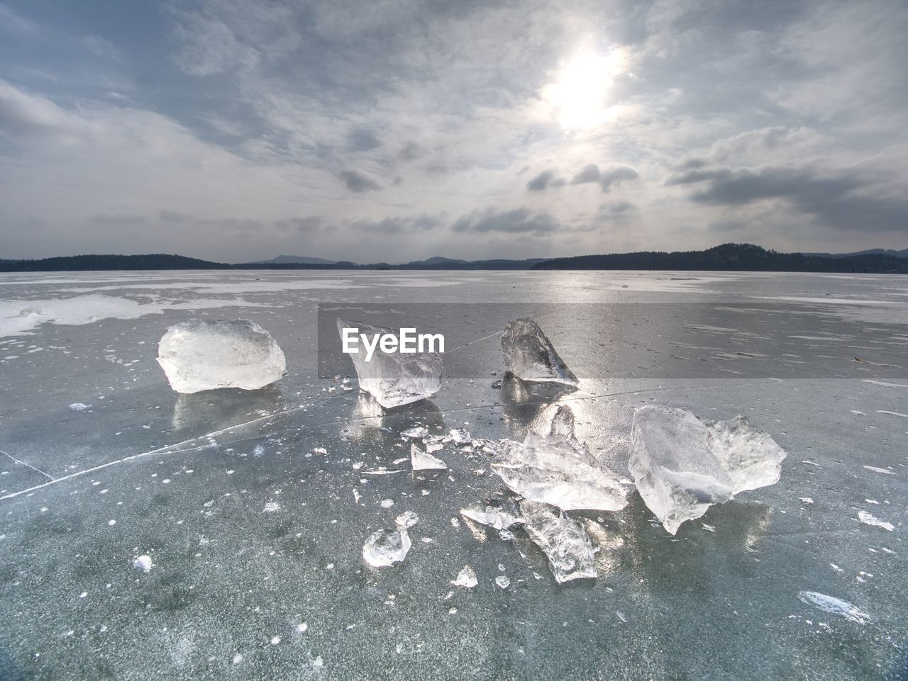 Melting of pieces of thick ice on frozen sea. hot sun begun thaw of glacier