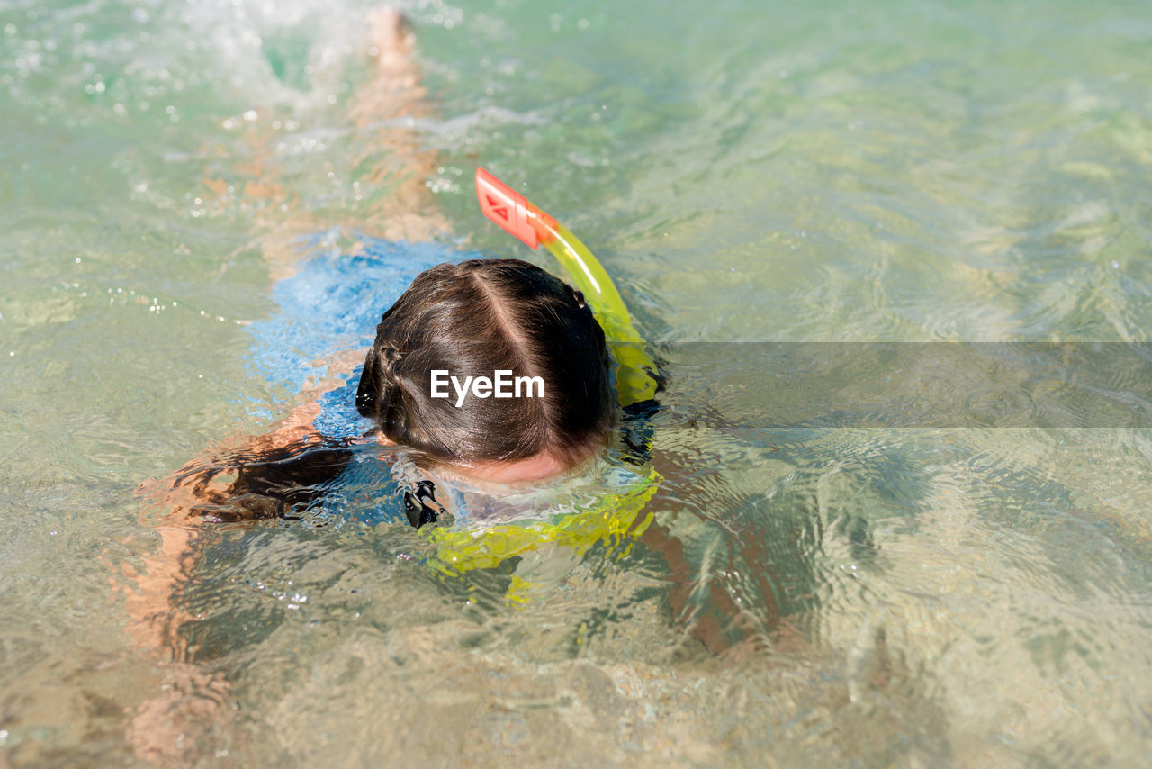 High angle view of girl swimming in pool