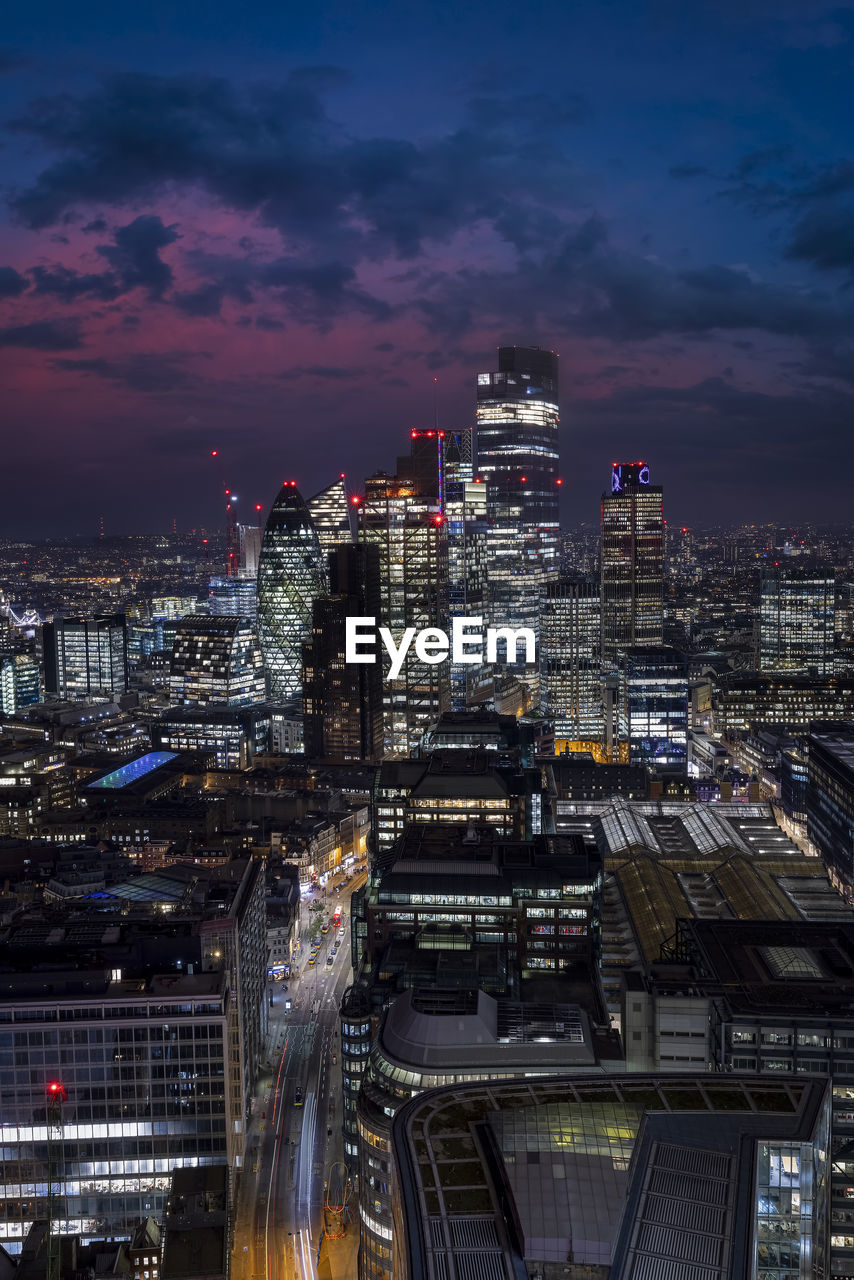 high angle view of illuminated buildings in city at night