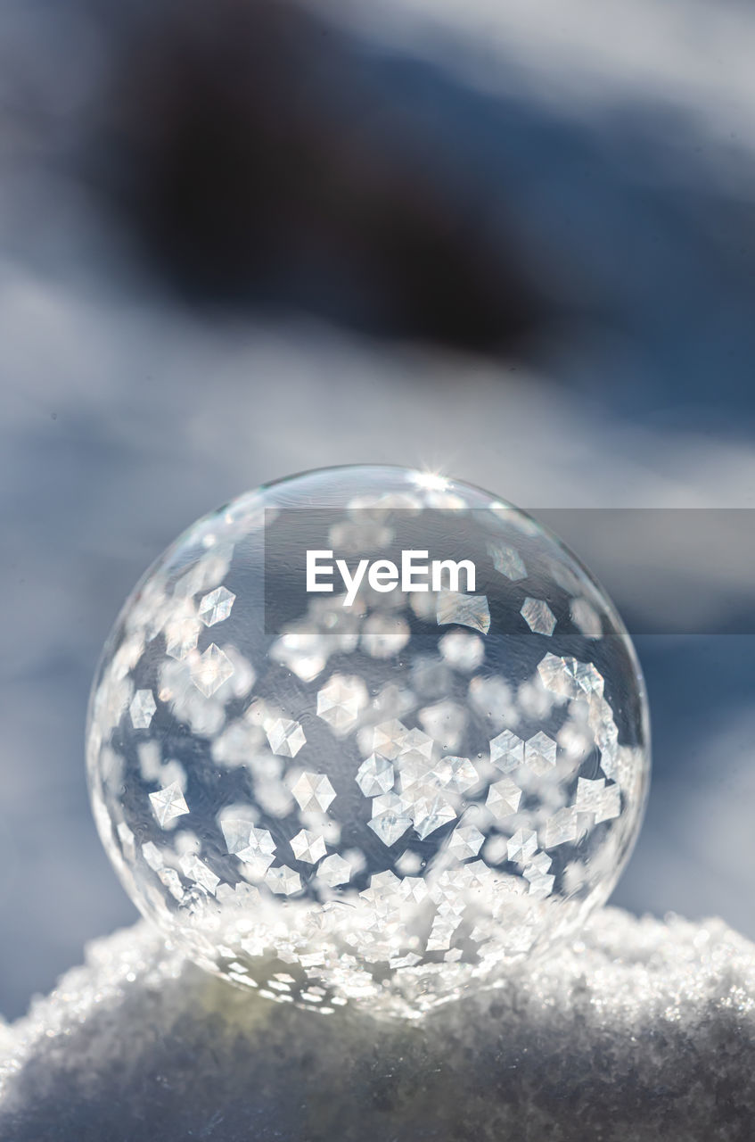 Close up image of soap bubble freezing in the snow on a winter's day.