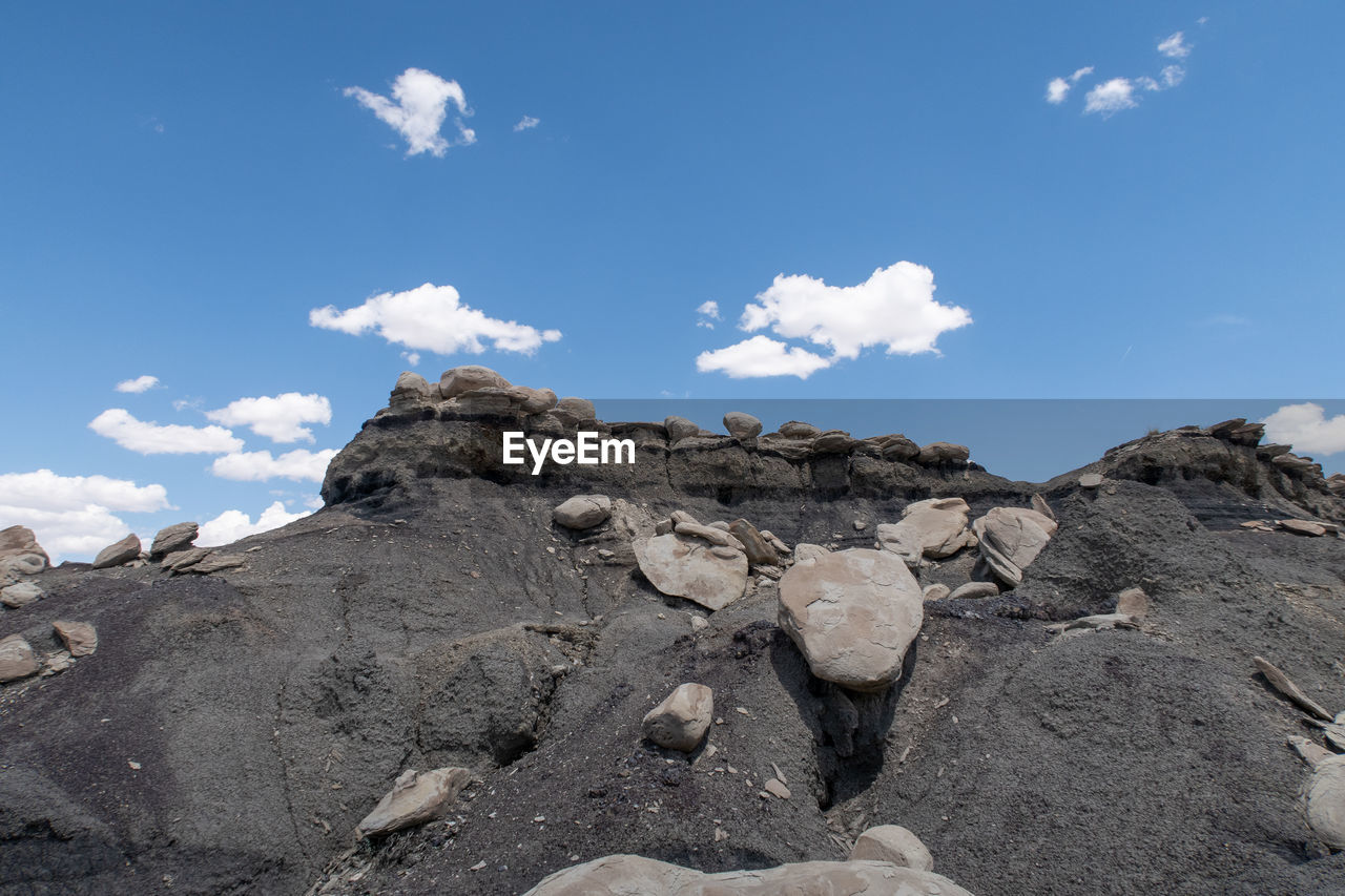 Low angle view of rocks against sky