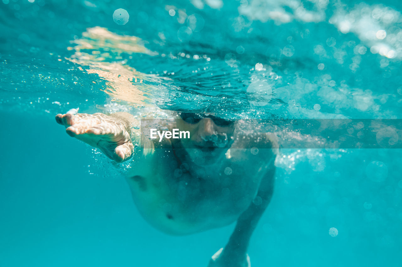 high angle view of man swimming in sea