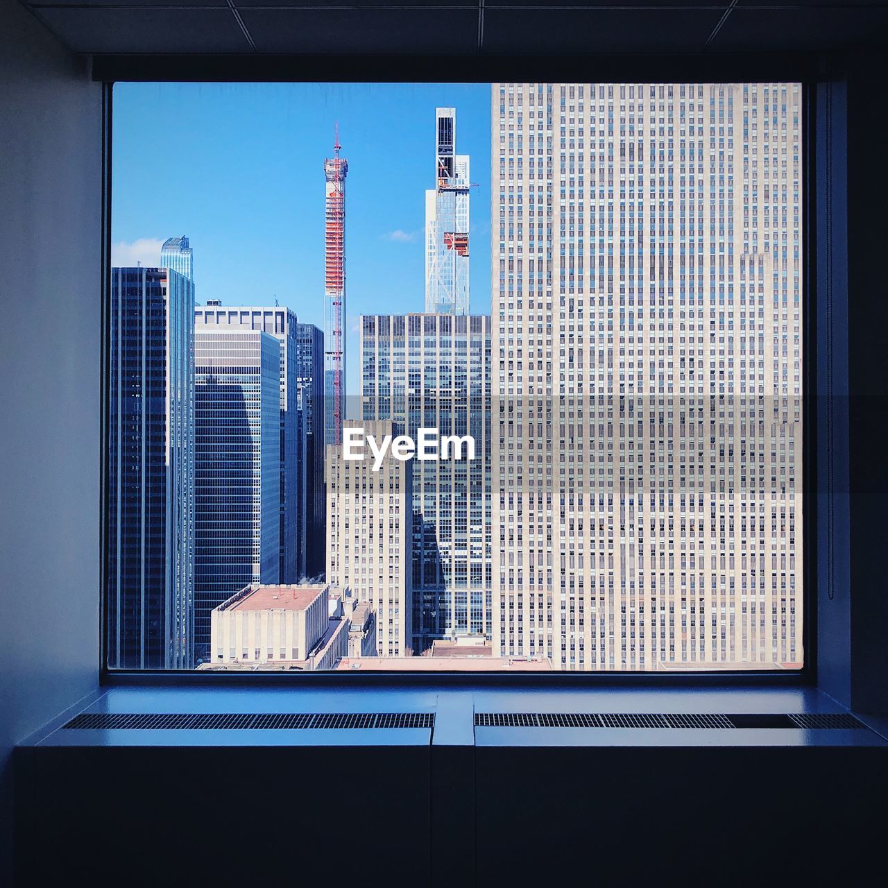 Modern buildings seen through glass window