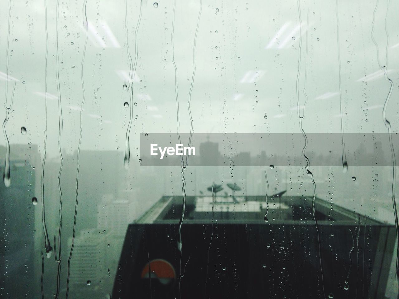 Close-up of wet glass window in rainy season