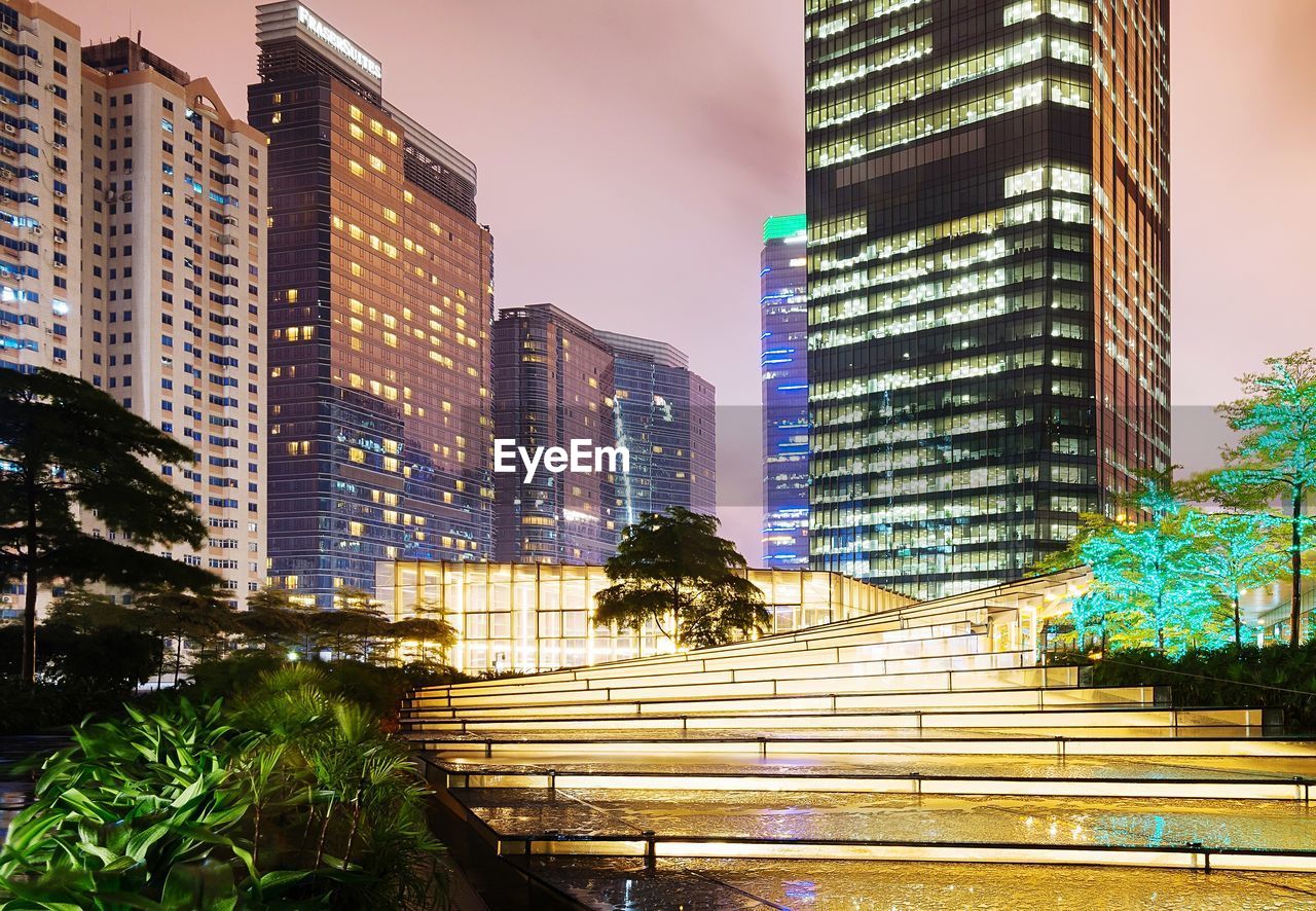 LOW ANGLE VIEW OF ILLUMINATED BUILDINGS AGAINST SKY