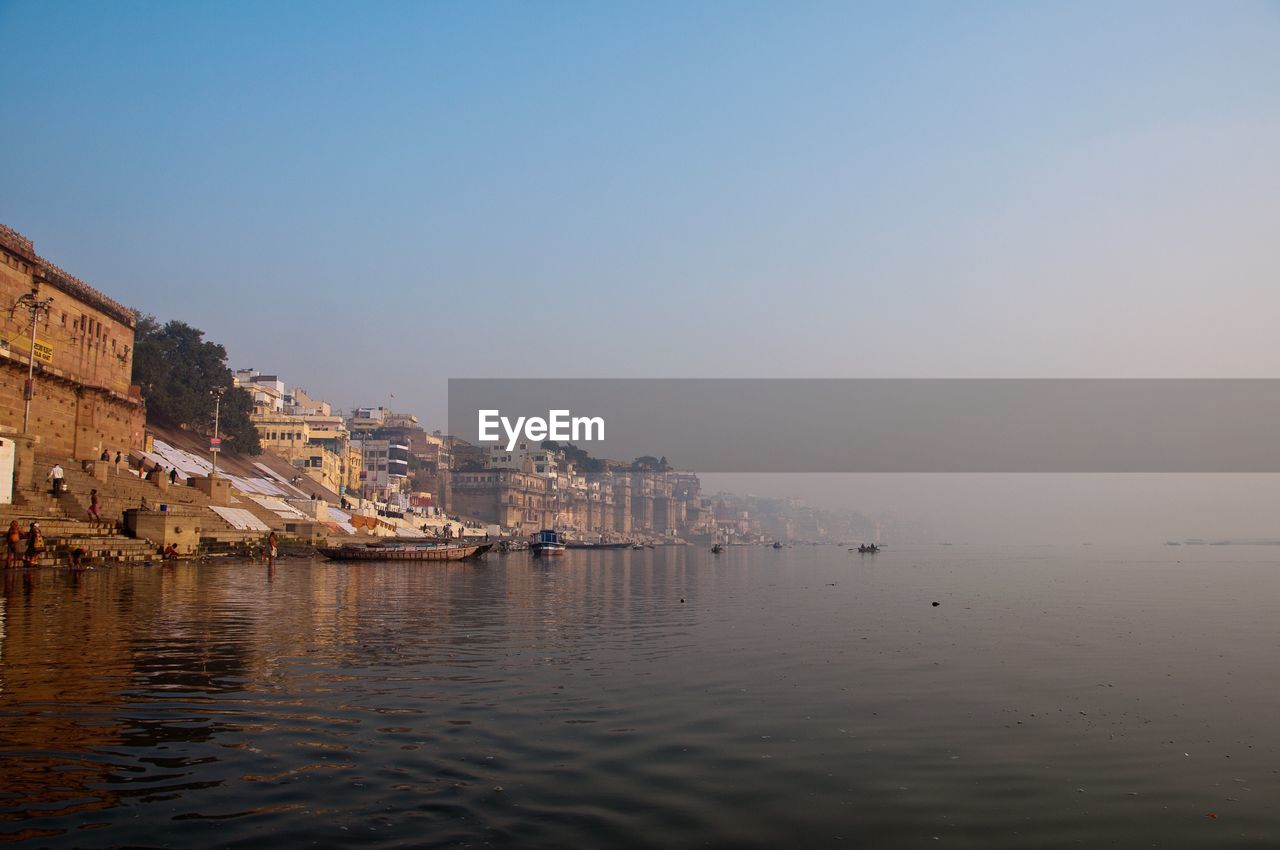 Scenic view of varanasi waterfront against clear sky