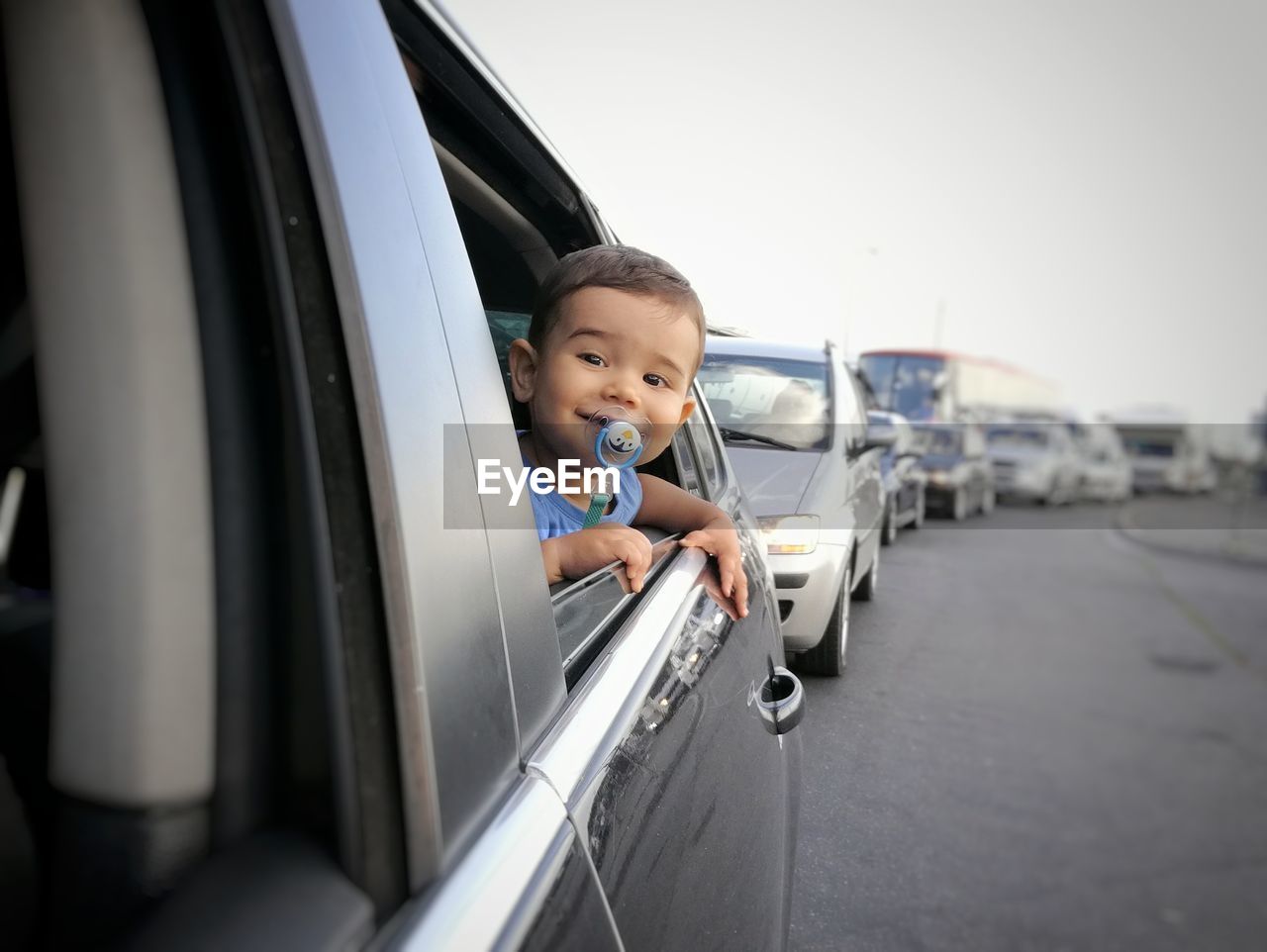 Funny toddler boy in car