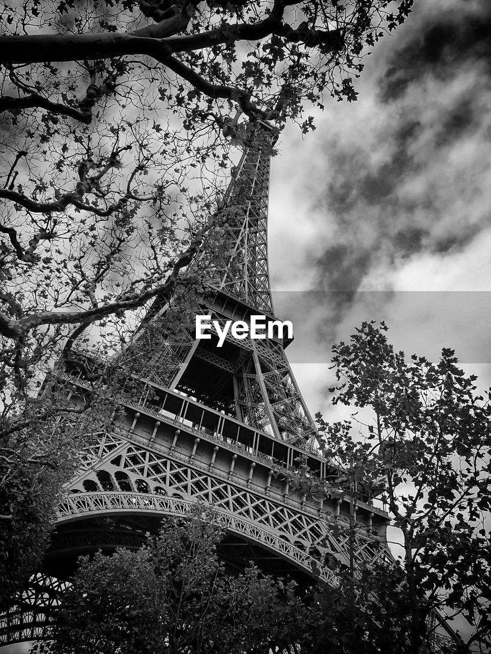 Low angle view of eiffel tower against cloudy sky