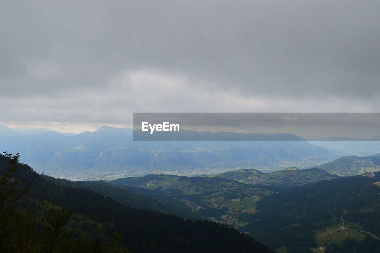 Scenic view of mountains against cloudy sky